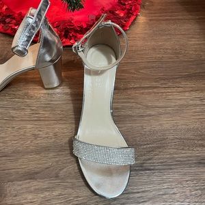 Silver heels with a rhinestone strap. Runs true to size. Only wore once.